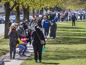 A lineup, that at one point stretched for about 1.5 km, for a Mobile Vaccine Clinic at Parkway Forest Community Centre near Sheppard Ave. E., and Don Mills Rd. in Toronto, on Monday April 19, 2021.