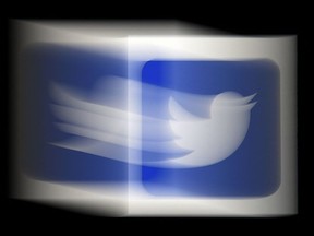 In this file illustration photo taken on August 10, 2020, a Twitter logo is displayed on a mobile phone  in Arlington, Virginia.