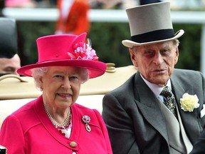 In this file photo taken on June 16, 2015 Britain’s Queen Elizabeth II and Britain’s Prince Philip, Duke of Edinburgh arrive by horse-drawn carriage on the first day of the annual Royal Ascot horse racing event near Windsor, Berkshire.