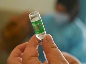 In this file photo a medical worker prepares a dose of the Covishield, AstraZeneca-Oxford's Covid-19 coronavirus vaccine, at a vaccination center in Srinagar on April 9, 2021 as India surged past 13 million coronavirus cases.