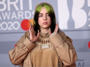 Billie Eilish poses as she arrives for the Brit Awards at the O2 Arena in London, Feb. 18, 2020.