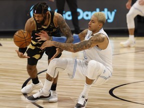 Los Angeles Lakers forward Kyle Kuzma drives to the basket as Toronto Raptors guard DeAndre' Bembry steals the ball during the first quarter at Amalie Arena.