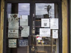 Pandemic related signage along Queen St. W. near Trinity Bellwoods Park in Toronto, Ont.  on Sunday February 28, 2021.