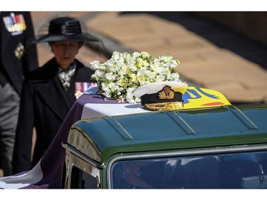 A military hat rests on the coffin of Prince Philip as it is transported by the hearse, a specially modified Land Rover, during the funeral of Britain's Prince Philip, husband of Queen Elizabeth, who died at the age of 99, on the grounds of Windsor Castle in Windsor, Britain, April 17, 2021. Leon Neal/Pool via REUTERS ORG XMIT: GDN