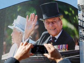 A screen in Piccadilly Circus displays images of Britain's Prince Philip, husband of Queen Elizabeth, who died at the age of 99, in London, Britain, April 17, 2021.