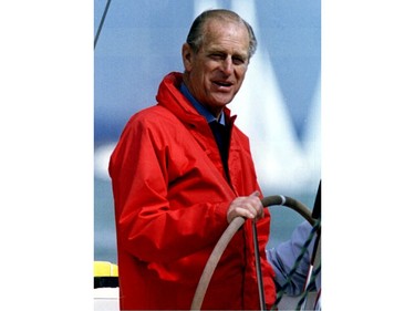 Prince Philip, the Duke of Edinburgh, smiles while at the helm of the yacht Yeoman XXVIII on July 31, 1993.