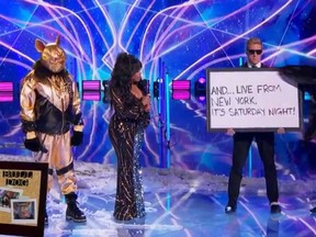 Nick Cannon, left, is dressed as the Bulldog on Fox's "The Masked Singer."