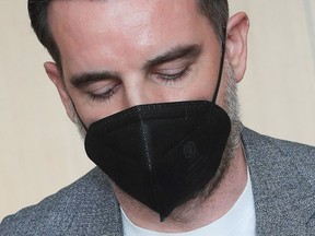 Former soccer player Christoph Metzelder looks down at the beginning of his trial, at a regional court in Duesseldorf, Germany, April 29, 2021.