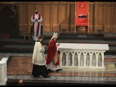 Cardinal Thomas Collins of the Roman Catholic Archdiocese of Toronto delivers the Good Friday liturgy at St. Michael's Cathedral Basilica. The church capacity could only be at  15% for parishioners as COVID rules still apply to places of worship on Friday April 2, 2021. Jack Boland/Toronto Sun/Postmedia Network