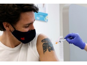 Canada's Prime Minister Justin Trudeau is inoculated with AstraZeneca's vaccine against coronavirus disease (COVID-19) at a pharmacy in Ottawa, Ontario, Canada April 23, 2021.   REUTERS/Blair Gable ORG XMIT: GGG-OTW106