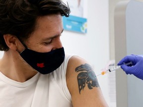 Canada's Prime Minister Justin Trudeau is inoculated with AstraZeneca's vaccine against coronavirus disease (COVID-19) at a pharmacy in Ottawa, Ontario, Canada April 23, 2021.