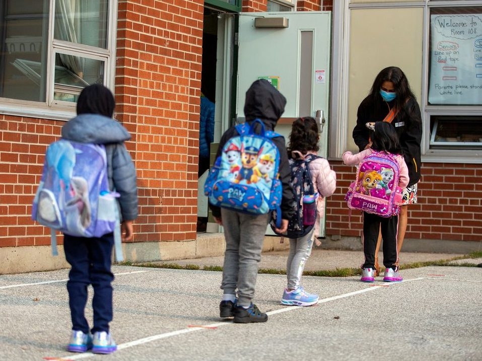 Students arrive for the first time since the start of the coronavirus disease (COVID-19) pandemic at Hunter's Glen Junior Public School, part of the Toronto District School Board (TDSB) in Scarborough, Ontario, Canada September 15, 2020. 
