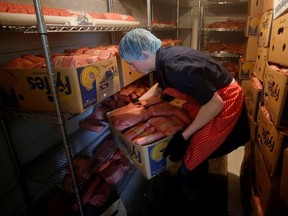 Butcher Allan vande Bruinhorst freezes beef as part of his uncle's business which allows farmers to circumvent the supply chain blockage caused by coronavirus disease (COVID-19) outbreaks at meatpacking plants, in Picture Butte, Alberta, Canada June 17, 2020.