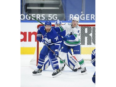 Toronto Maple Leafs T.J. Brodie D (78) defends in front of the net with Vancouver Canucks Brock Boeser LW (6) during the second period in Toronto on Thursday April 29, 2021. Jack Boland/Toronto Sun/Postmedia Network