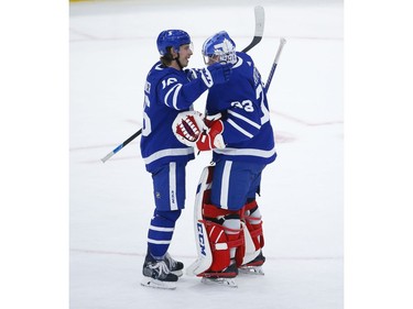 Toronto Maple Leafs David Rittich G (33) is congratulated by teammate Mitch Marner after winning the game in Toronto on Thursday April 29, 2021. Jack Boland/Toronto Sun/Postmedia Network