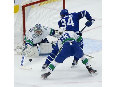 Vancouver Canucks Braden Holtby G (49) poke checks Toronto Maple Leafs Auston Matthews C (34) as he comes in to try and score during the first period in Toronto on Thursday April 29, 2021. Jack Boland/Toronto Sun/Postmedia Network