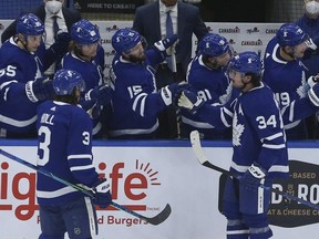Toronto Maple Leafs' Auston Matthews gets congrats from the bench after scoring early in the second period against the Canucks in Toronto on Thursday, April 29, 2021.