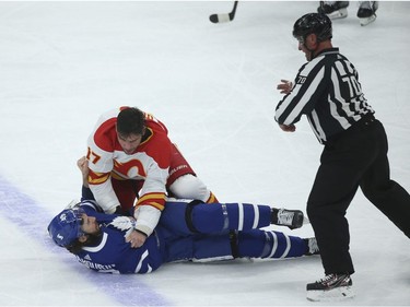 Calgary Flames Milan Lucic LW (17) fights Toronto Maple Leafs Scott Sabourin RW (49) during the first period in Toronto. It is Lucic's 100th game as a player  on Tuesday April 13, 2021. Jack Boland/Toronto Sun/Postmedia Network