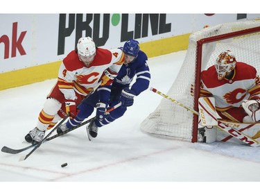 Toronto Maple Leafs Zach Hyman C (11)chases down Calgary Flames Rasmus Andersson D (4) during the first period in Toronto on Tuesday April 13, 2021. Jack Boland/Toronto Sun/Postmedia Network