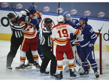 Toronto Maple Leafs Justin Holl (3) and Calgary Flames Matthew Tkachuk LW (19) get into in front of David Rittich G (33) during the first period in Toronto on Tuesday April 13, 2021. Jack Boland/Toronto Sun/Postmedia Network