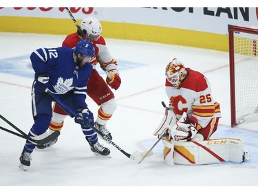 Calgary Flames Jacob Markstrom G (25) makes a save on Toronto Maple Leafs Alex Galchenyuk C (12) during the second period in Toronto on Tuesday April 13, 2021. Jack Boland/Toronto Sun/Postmedia Network