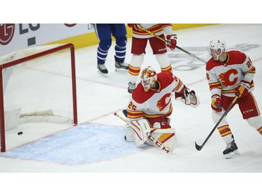 Calgary Flames Jacob Markstrom G (25) watches the puck beat him off a shot by Toronto Maple Leafs Alexander Kerfoot C (15) during the third period in Toronto on Tuesday April 13, 2021. Jack Boland/Toronto Sun/Postmedia Network