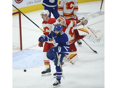 Toronto Maple Leafs Alexander Kerfoot C (15)  buries a shot past Calgary Flames Jacob Markstrom G (25) during the third period in Toronto on Tuesday April 13, 2021. Jack Boland/Toronto Sun/Postmedia Network