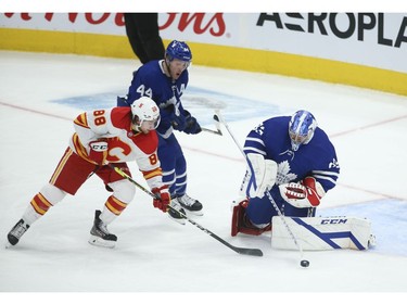 Toronto Maple Leafs David Rittich G (33) can't handle the puck and gives it away to Calgary Flames Andrew Mangiapane LW (88) during the third period in Toronto on Tuesday April 13, 2021. Jack Boland/Toronto Sun/Postmedia Network