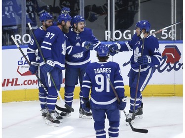 Toronto Maple Leafs Zach Hyman C (11) roofs a puck on the short side past Calgary Flames Jacob Markstrom G (25) during the first period in Toronto on Tuesday April 13, 2021. Jack Boland/Toronto Sun/Postmedia Network