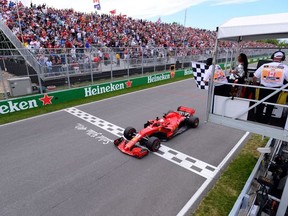 Formula One F1 - Canadian Grand Prix - Circuit Gilles Villeneuve, Montreal, Canada - June 10, 2018   Ferrari's Sebastian Vettel passes the chequered flag to win the race.