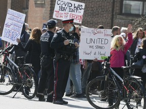 Protesters in front of the College of Nurses of Ontario building on Davenport Ave in Toronto on Wednesday, April 14, 2021.