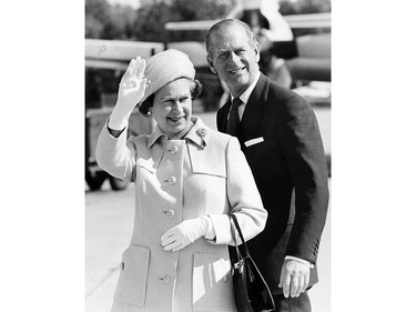 In this file photo taken on Oct. 1, 1984, the Queen and Prince Philip wave goodbye in Windsor, Ont., as they leave for Brantford, Ont.