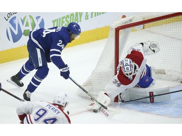 Toronto Maple Leafs Wayne Simmonds RW (24) tries to jam the puck in under the glove of Montreal Canadiens Jake Allen G (34)during the first period in Toronto on Wednesday April 7, 2021. Jack Boland/Toronto Sun/Postmedia Network