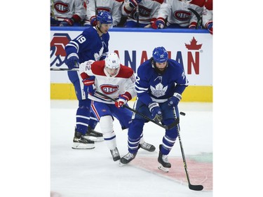 Toronto Maple Leafs Zach Bogosian D (22) palms the puck away from Montreal Canadiens Artturi Lehkonen RW (62) during the third period in Toronto on Wednesday April 7, 2021. Jack Boland/Toronto Sun/Postmedia Network