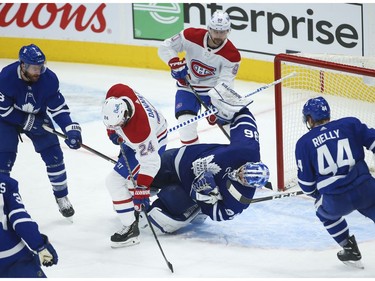 Montreal Canadiens Phillip Danault C (24) slams into Toronto Maple Leafs Jack Campbell G (36) during a scramble in front of the net during the third period in Toronto on Wednesday April 7, 2021. Jack Boland/Toronto Sun/Postmedia Network