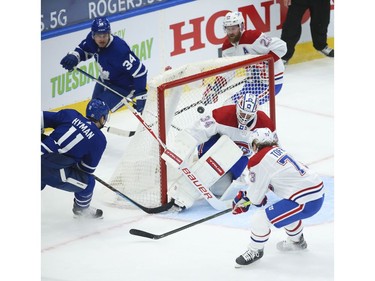 Toronto Maple Leafs Zach Hyman C (11) roofs the puck past Montreal Canadiens Jake Allen G (34) during the third period in Toronto on Wednesday April 7, 2021. Jack Boland/Toronto Sun/Postmedia Network