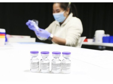 Lirie Palamind an RPN loads up syringes of  Pfizer-BioNTech COVID-19 vaccine to be administered to 1,500 people on Wednesday at the Humber River Hospital Vaccination Clinic held at Downsview Arena on Wednesday April 21, 2021. Jack Boland/Toronto Sun/Postmedia Network