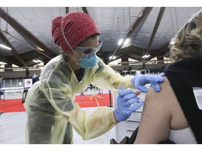 Dr. Tina Kerelska vaccinates people at  Downsview Arena on  April 21, 2021.