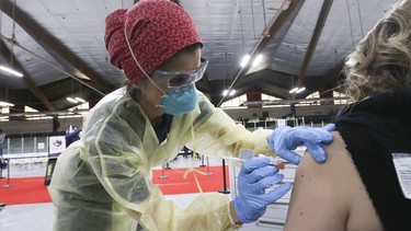 Dr. Tina Kerelska vaccinates people at  Downsview Arena on  April 21, 2021.