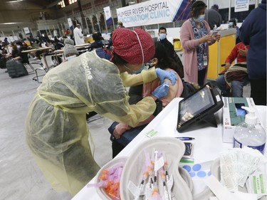 Dr. Tina Kerelska an anesthesiologist helps to vaccinate some of the 1,500 people with Pfizer-BioNTech COVID-19 vaccine on Wednesday at the Humber River Hospital Vaccination Clinic held at Downsview Arena on Wednesday April 21, 2021. Jack Boland/Toronto Sun/Postmedia Network