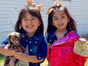 Gianella and Luna pose with their new puppy.