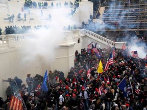 Police release tear gas into a crowd of pro-Trump protesters during clashes at a rally to contest the certification of the 2020 U.S. presidential election results by the U.S. Congress, at the U.S. Capitol Building in Washington, U.S, January 6, 2021.