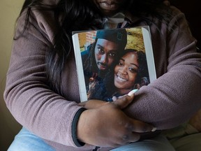 Lashonnah Nix, sister of Lymond Moses, who was shot and killed by police, poses for a portrait with a photo she embraces daily in Wilmington, Delaware, U.S., April 23, 2021. Picture taken April 23, 2021.