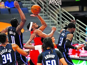 Raptors' Paul Watson  puts up a shot against four Orlando Magic players, en route to a career-best 30 points on Friday, April 16, 2021, in Tampa, Fla.