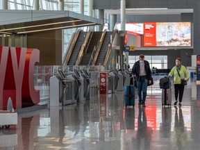 Passengers stroll the departure terminal at Calgary International Airport on Wednesday, April 14, 2021.