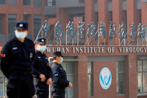 Security personnel keep watch outside the Wuhan Institute of Virology during the visit by the World Health Organization (WHO) team tasked with investigating the origins of the coronavirus disease (COVID-19), in Wuhan, Hubei province, China February 3, 2021.