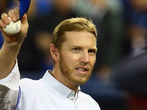 Roy Halladay walks to the dugout before the season opener between the Toronto Blue Jays and the New York Yankees during MLB action at the Rogers Centre in Toronto, Ont. on Friday April 4, 2014.