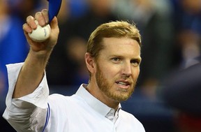 Roy Halladay walks to the dugout before the season opener between the Toronto Blue Jays and the New York Yankees during MLB action at the Rogers Centre in Toronto, Ont. on Friday April 4, 2014.