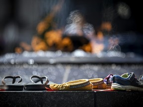 People came and went from Parliament Hill May 30, 2021, leaving behind shoes they set along the Centennial Flame in honour of the remains of 215 children that were found at a residential school in Kamloops, British Columbia that closed in 1978.