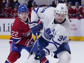 Auston Matthews #34 of the Toronto Maple Leafs handles the puck against Cole Caufield #22 of the Montreal Canadiens during the third period at the Bell Centre on May 3, 2021 in Montreal.